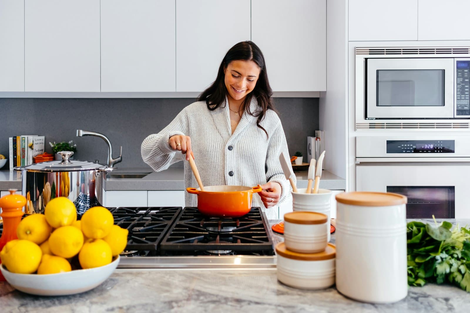 Caregiver preparing a meal in a bright home kitchen as part of everyday household support
